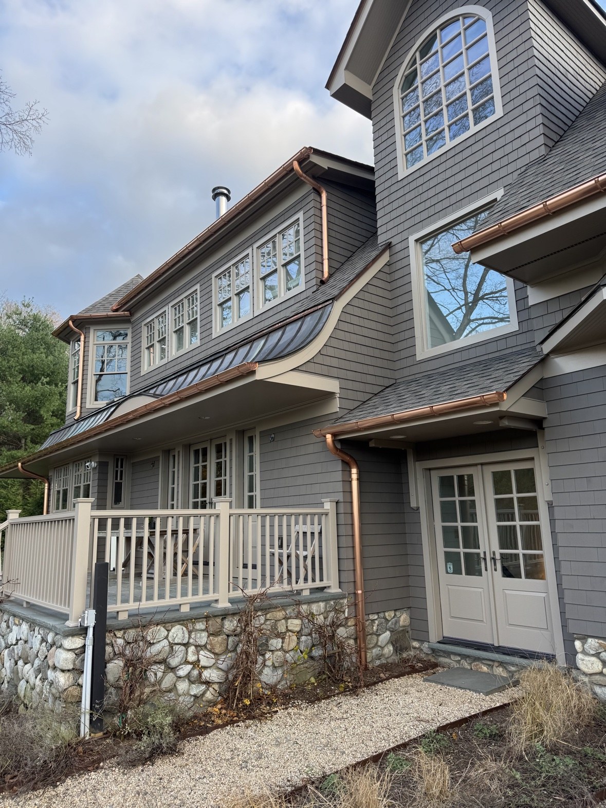 Copper gutters on gray home