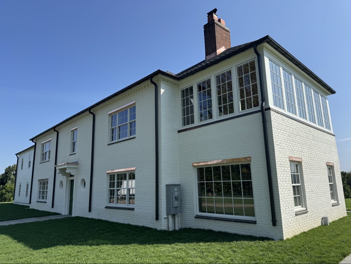 White brick home with black gutters