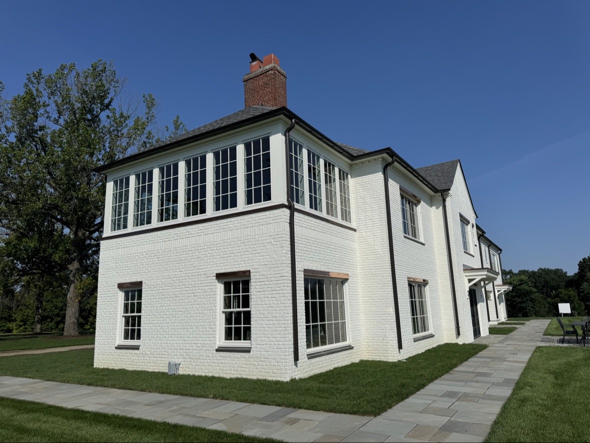 White brick home with black windows and new roof in Marlboro NJ