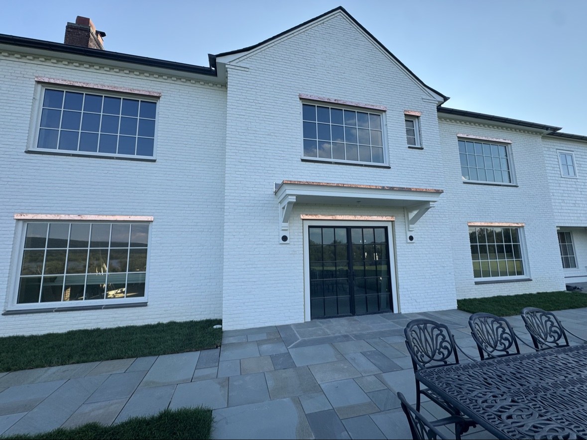 White brick home with patio