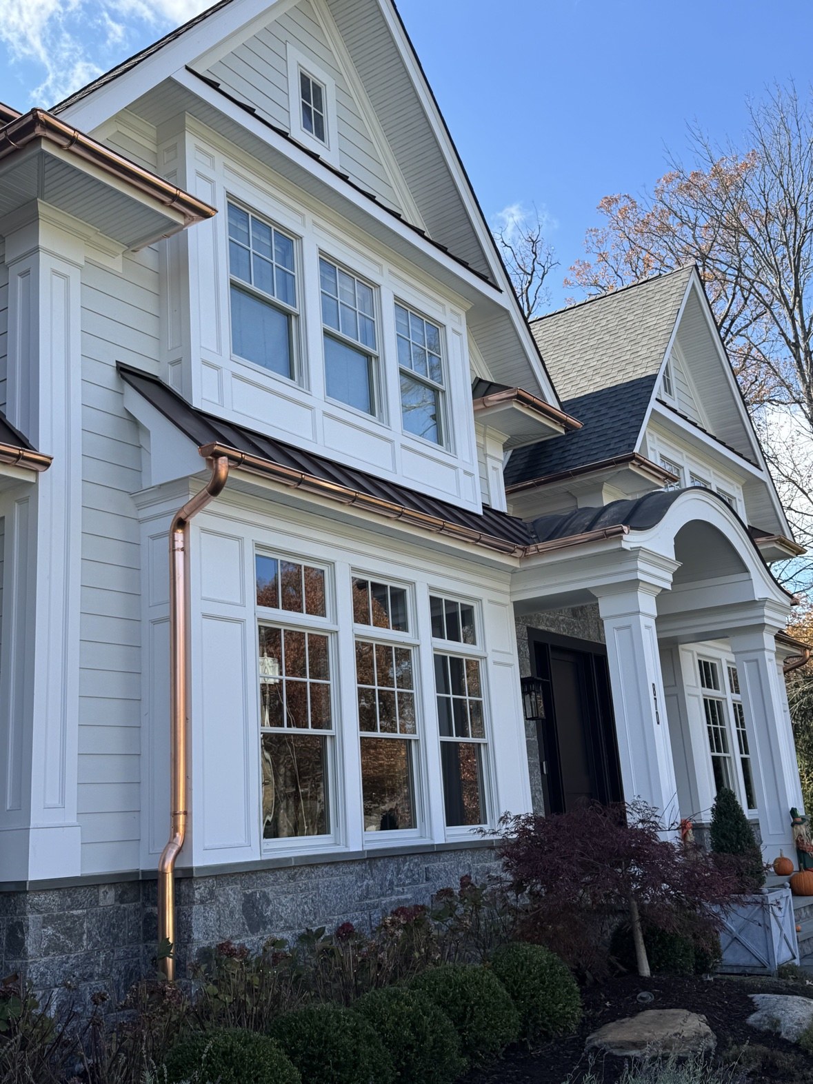 White home with copper gutters and new windows